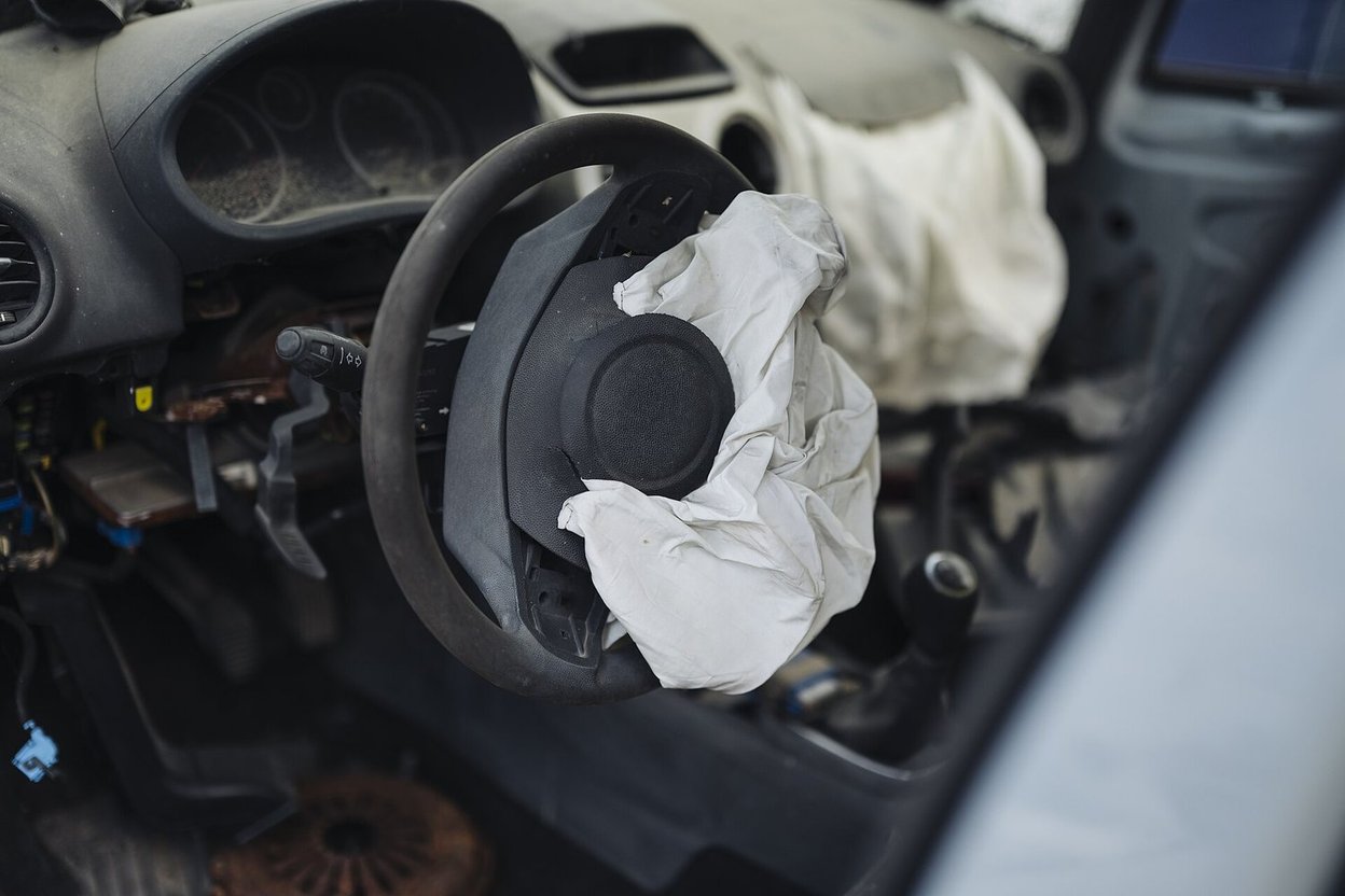 A car interior with a deployed airbag