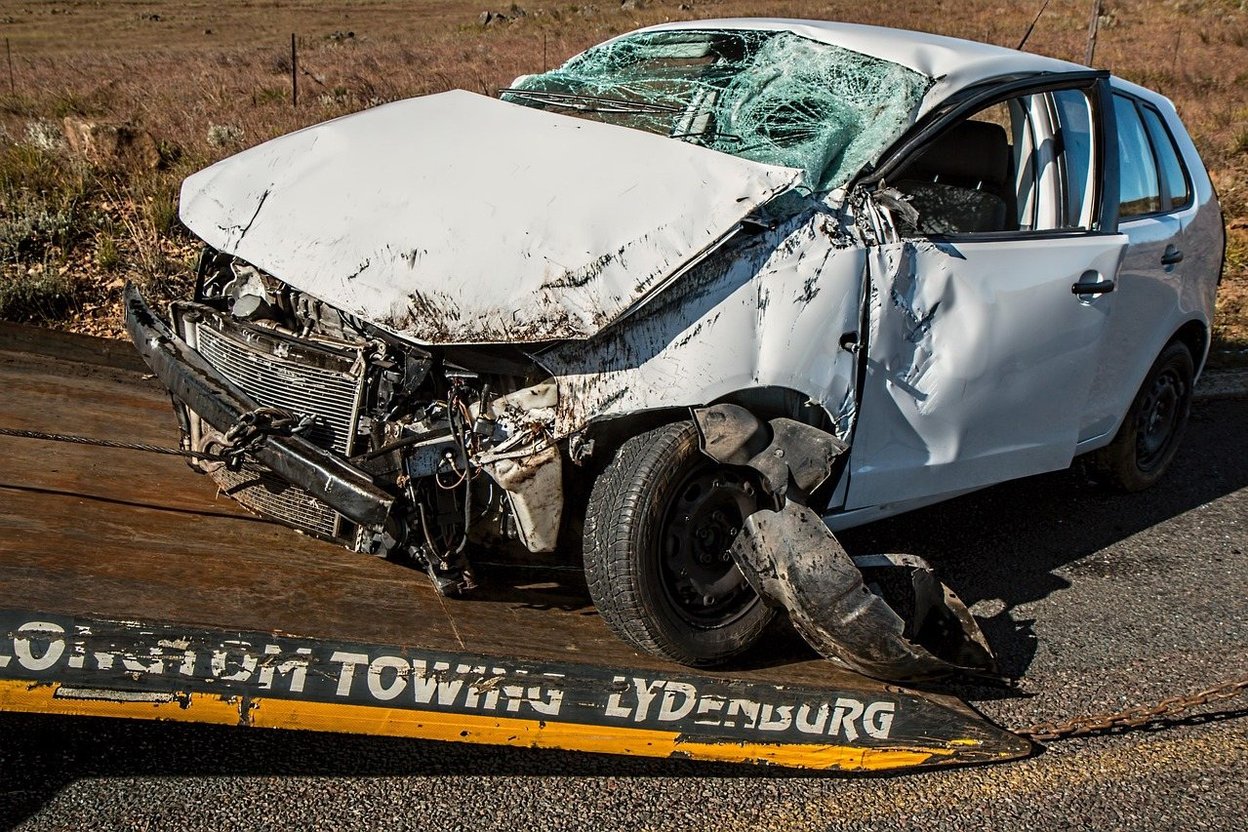 A person reviewing a vehicle history report on a phone