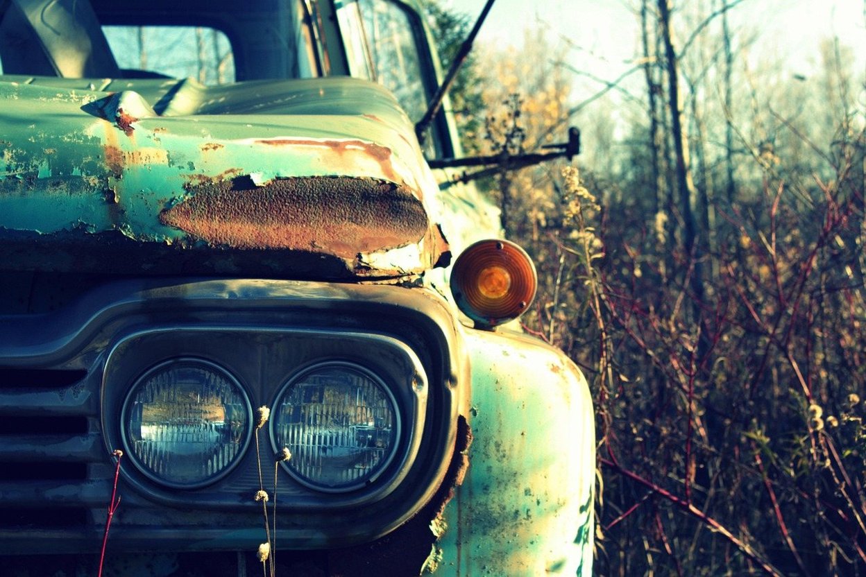 Rows of damaged cars in an auction salvage yard