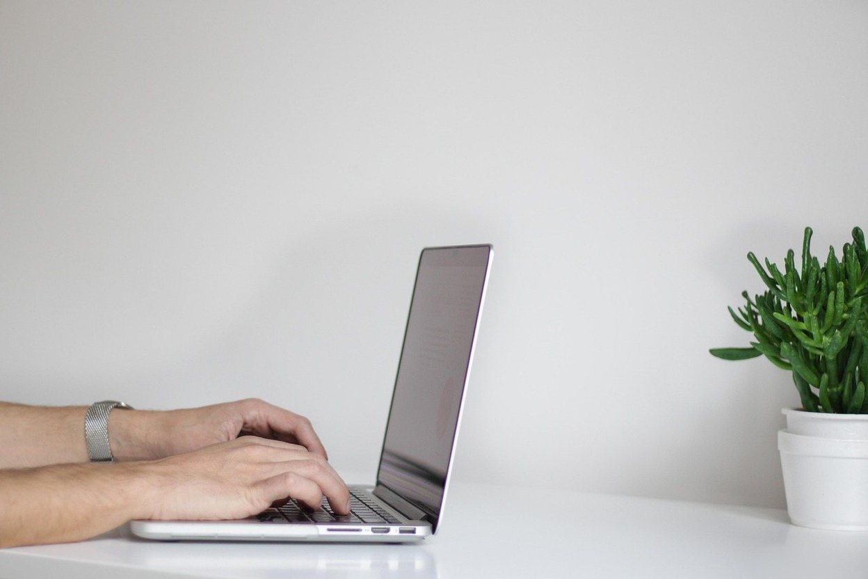 A person looking at an online car auction on a laptop