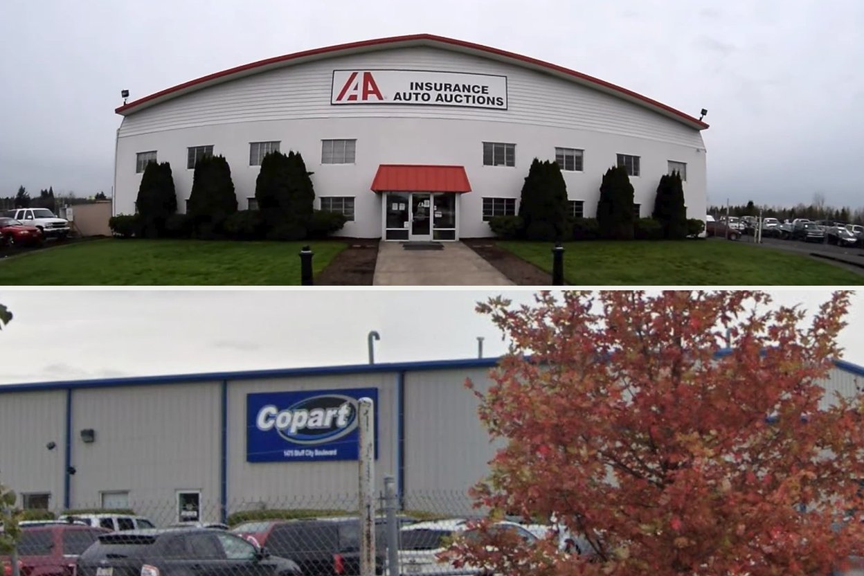 An Insurance Auto Auctions building with its IAA sign above a Copart building with its blue Copart sign