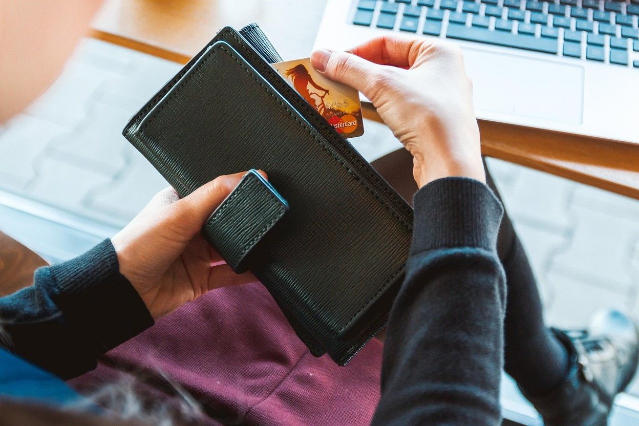 A person paying online with a credit card at a laptop