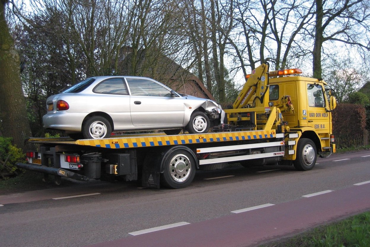 A car on a flatbed tow truck