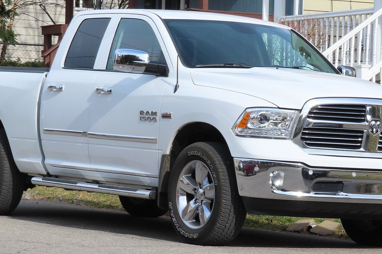 A white 2013–2018 Ram 1500 Quad Cab pickup