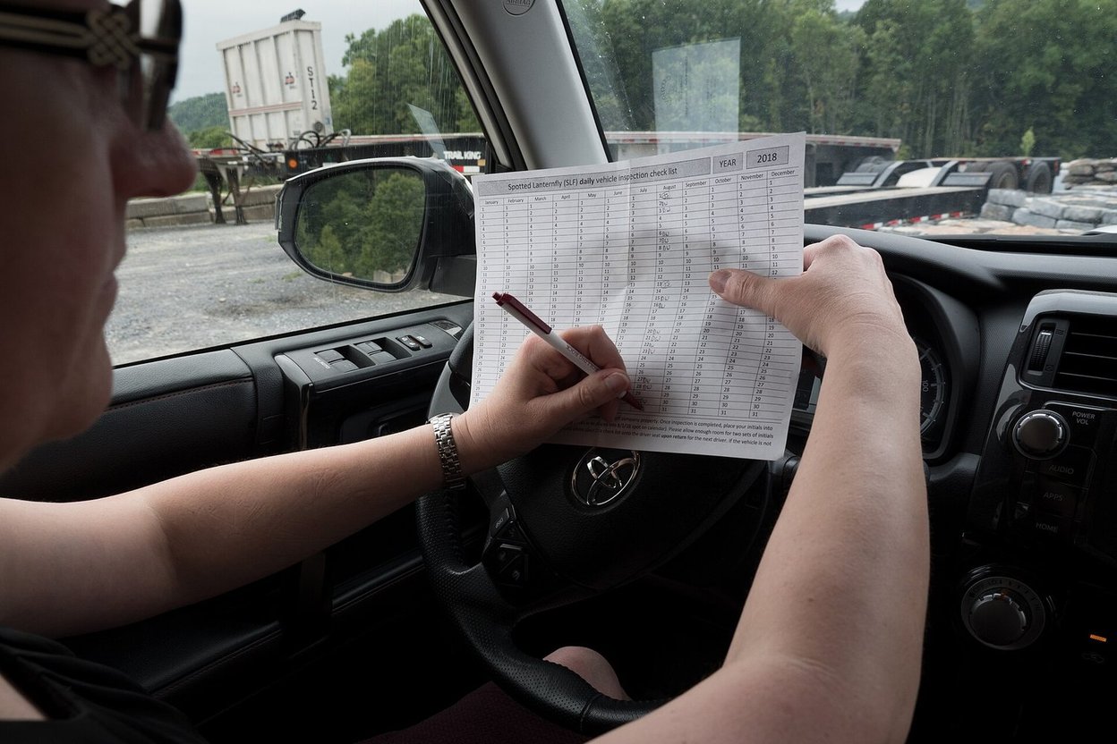 A car's VIN plate visible through the windshield